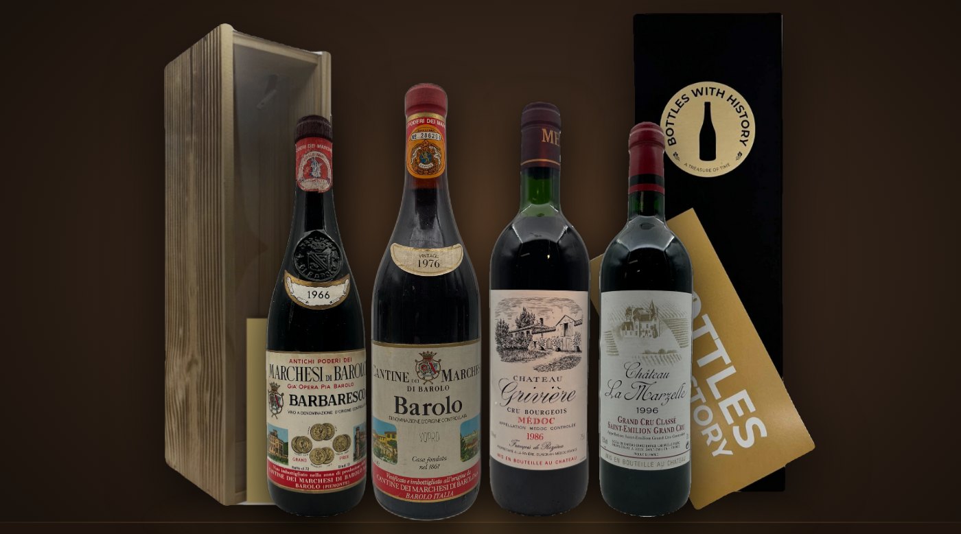 Vuosikertaviinit vuosilta 1966, 1976, 1986 ja 1996 Bottles With Historyn puisten ja mustien lahjarasioiden edessä